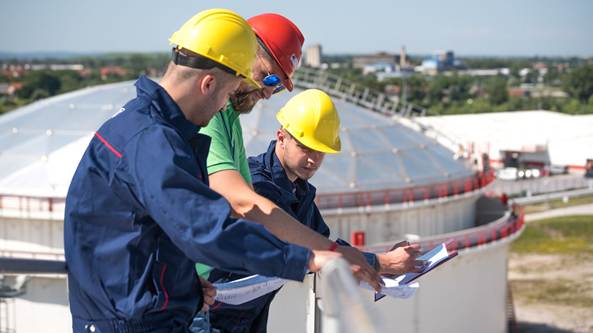 A group of men wearing hard hats

Description automatically generated